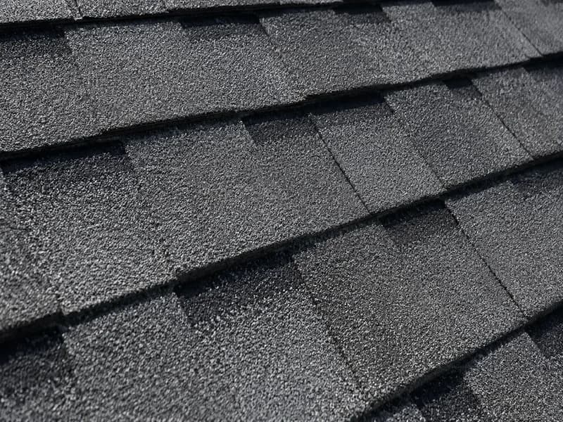 Close-up of architectural asphalt shingle texture and tab pattern